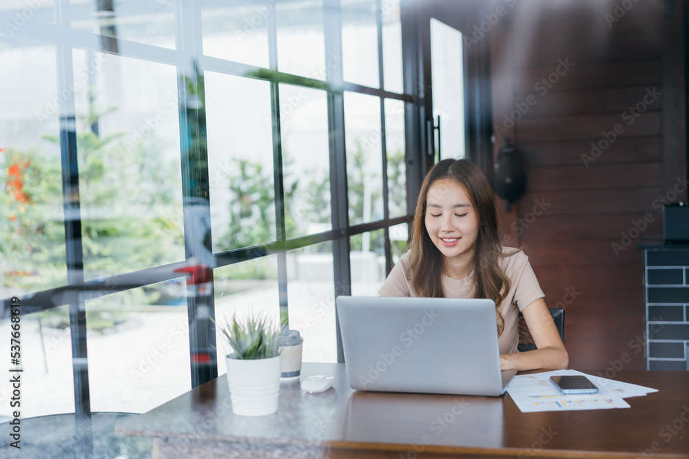 Freelance Freelancer asian woman smiling her working with laptop computer and smartphone for working job at workspace. small business with freedom lifestyle concept. Freelance Freelancer asian woman smiling her working with laptop computer and smartphone for working job at workspace. small business with freedom lifestyle concept.