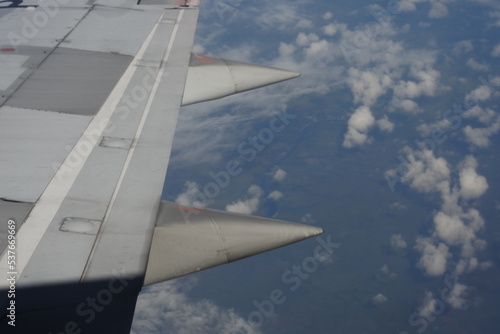 The view from the airplane window. summer day airplane flying over sky view and airplane wings. the deep blue sky and clouds from the plane