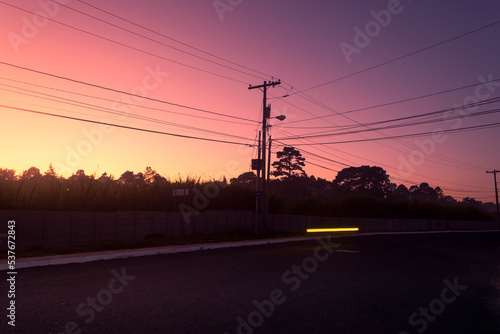 Silhouette of power poles in urban area of latin america city, attractive sky, showing technology and progress.