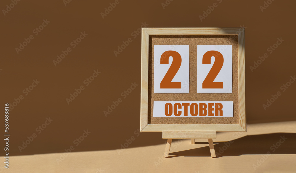 October 22th. Day 22 of month, Calendar date. Cork board, easel in sunlight on desktop. Close-up, brown background. Autumn month, day of year concept October 22th. Day 22 of month, Calendar date. Cork board, easel in sunlight on desktop. Close-up, brown background. Autumn month, day of year concept