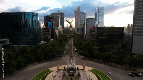 drone shot from the front of a sunset on the paseo de la reforma in mexico city with a close view of the monument to independence photo