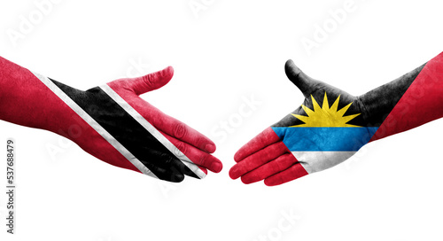 Handshake between Antigua and Barbuda and Trinidad Tobago flags painted on hands, isolated transparent image.