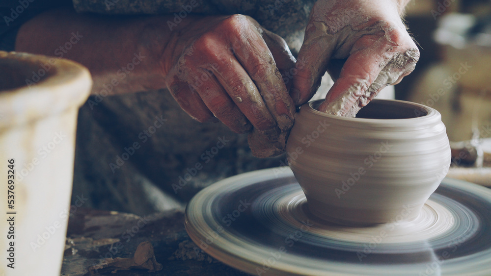 Work in pottery clay ware on throwing wheel, master ceramist