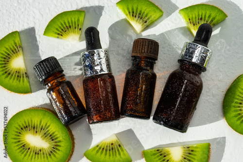 Kiwi butter. a skin and hair care product. Serum in a glass bottle with a pipette. Kiwi seed oil in a kiwi jar. The concept of aromatherapy  spa  beauty treatments and body care. Selective focus. 