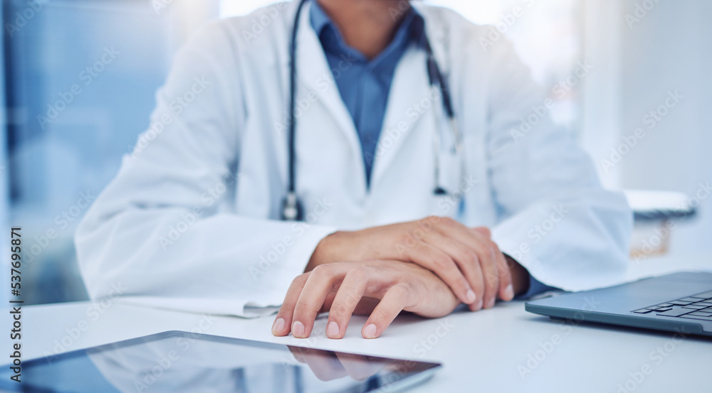 Hands, tablet and healthcare with a doctor at a desk in the hospital for medicine, insurance or consulting. Trust, medical and internet with a male surgeon sitting in a clinic for health or wellness Hands, tablet and healthcare with a doctor at a desk in the hospital for medicine, insurance or consulting. Trust, medical and internet with a male surgeon sitting in a clinic for health or wellness