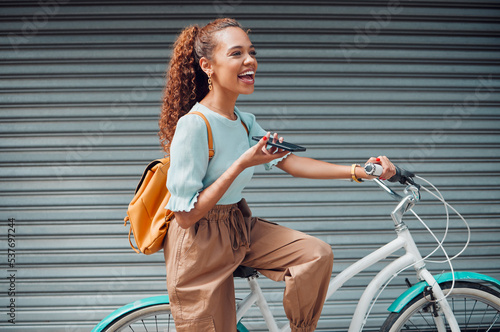 Bike, woman and with phone in city with bicycle talk while outdoor in summer with fresh, edgy and trendy look. Eco friendly transportation, smile and happy girl have conversation, relax and in street