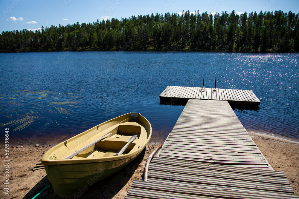 Boat and jetty on a Lake in Finland Boat and jetty on a Lake in Finland