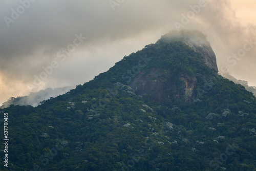 Dramatic clouds on the Pico do Andaraí Maior peak above the dense Atlantic rainforest of the Tijuca National Park, Rio de Janeiro, Brazil