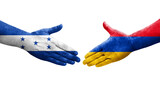 Handshake between Armenia and Honduras flags painted on hands, isolated transparent image.