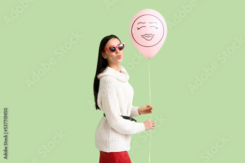 Stylish young woman holding...