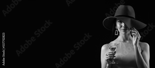 Photography Black and white portrait of beautiful young woman drinking martini on dark backg