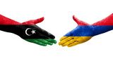 Handshake between Armenia and Libya flags painted on hands, isolated transparent image.
