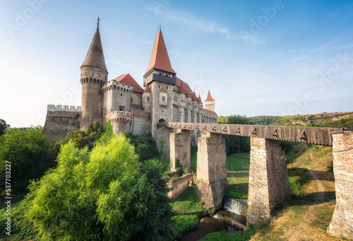 Summer view with Corvin castle with bridge over a small river in a sunny day in Romania