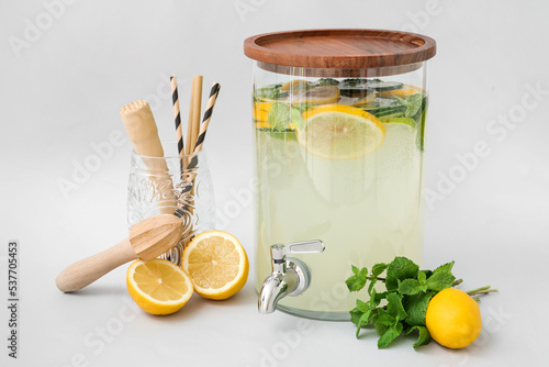 Jar of delicious lemonade on light background