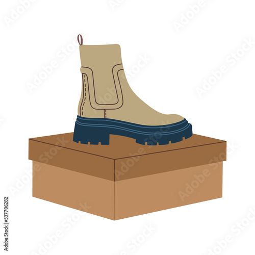 Trendy light brown chelsea boots on the box. Modern stylish casual footwear. Hand drawn vector illustration isolated on white background. Modern flat cartoon style.