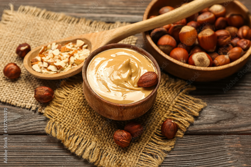 Bowl of tasty hazelnut butter on wooden table Bowl of tasty hazelnut butter on wooden table