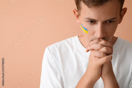 Young man with drawn flag o...