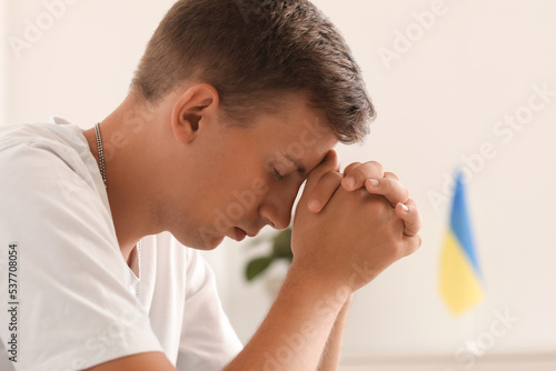 Handsome young man praying ...