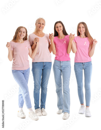 Beautiful women with pink awareness ribbons holding hands on white background. Breast cancer concept