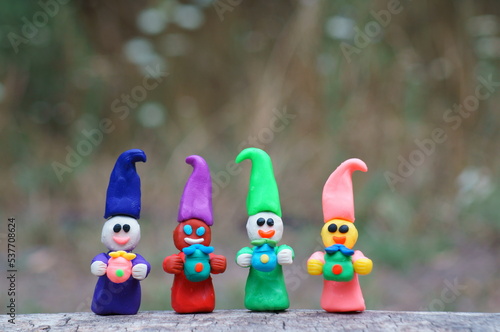 Figurines of colorful fairy-tale dwarfs with gifts. Decorations for the holiday  birthday.