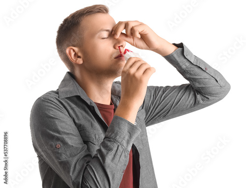 Young man wiping nosebleed ...