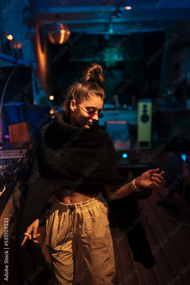 Obraz premium Beautiful female dancing in a small club