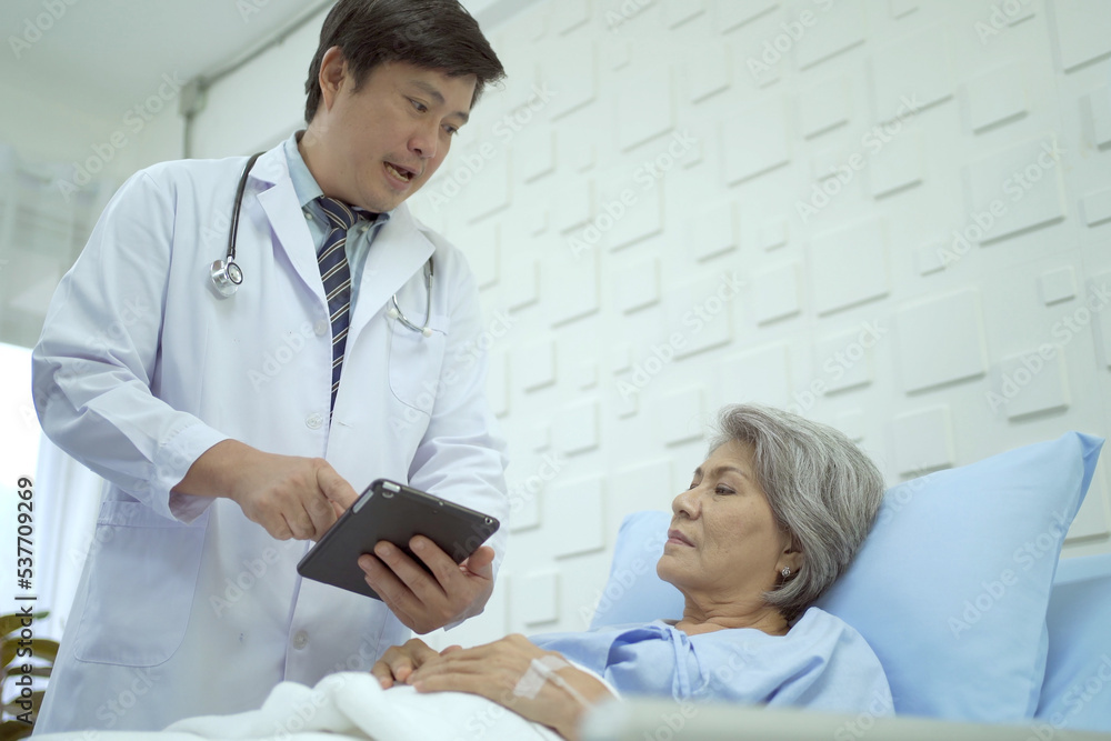 Fototapeta premium Specialist doctor or professional physician visiting a senior female patient in recovery ward hospital in hospital.