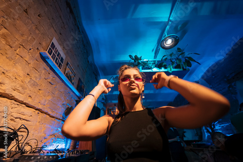 Bilde på lerret Beautiful female DJ dancing to techno in a small club