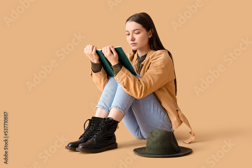 Young woman in jacket readi...