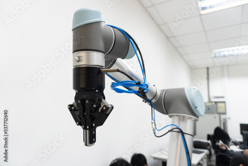 robotic arm catch for electronic assembly line. The robot for smart technology manufacturing process.