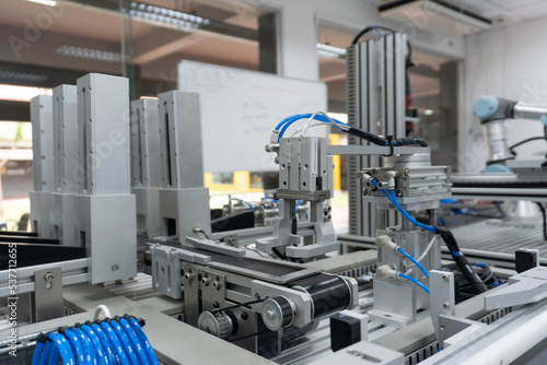 robotic arm catch for electronic assembly line. The robot for smart technology manufacturing process.