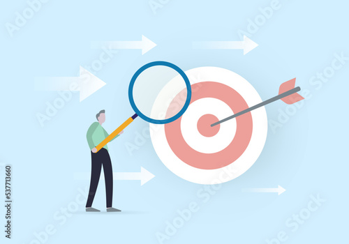 Business analysis to increase sale, marketing target audience research concept. Businessman holding magnifying glass analyzes the ultimate goal and directions of development to achieve it