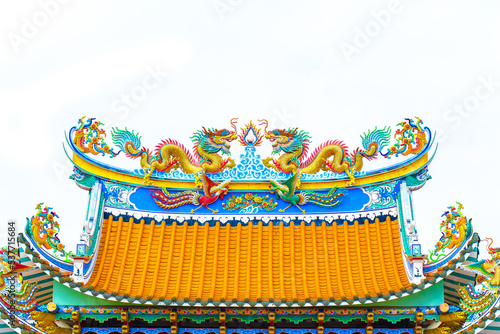 Chinese style Twin dragons statue on the roof of Chinese temple isolated white background
