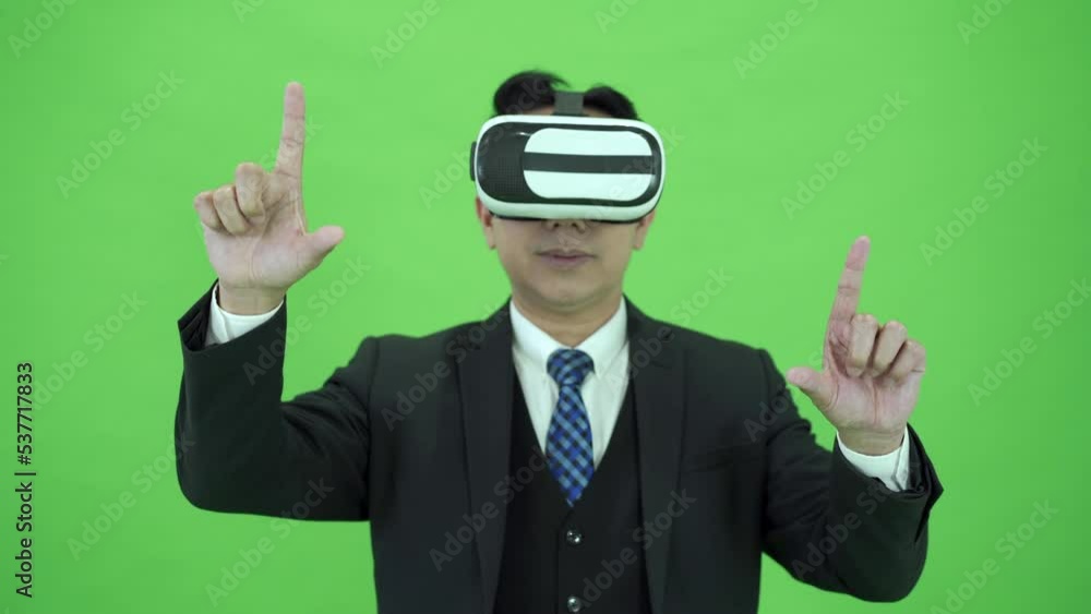 Businessman on Chroma Green Screen using gesture control while using