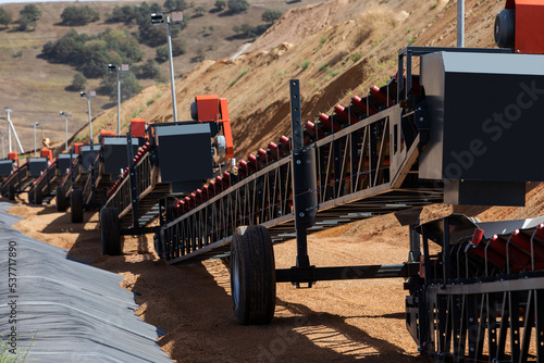 Empty conveyor belt sits  at a mining area.