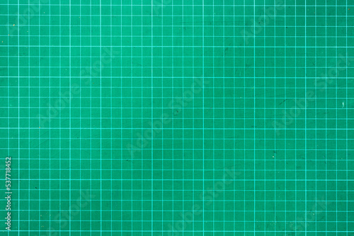 Plastic green cutting mat texture. squared sheet texture green background