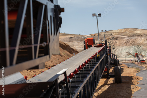 Empty conveyor belt sits  at a mining area.