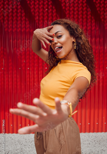 Fashion, beauty and cosmetics with a model black woman posing for makeup, manicure or cosmetic product. Hands, nails and style with an attractive young female standing against a red background