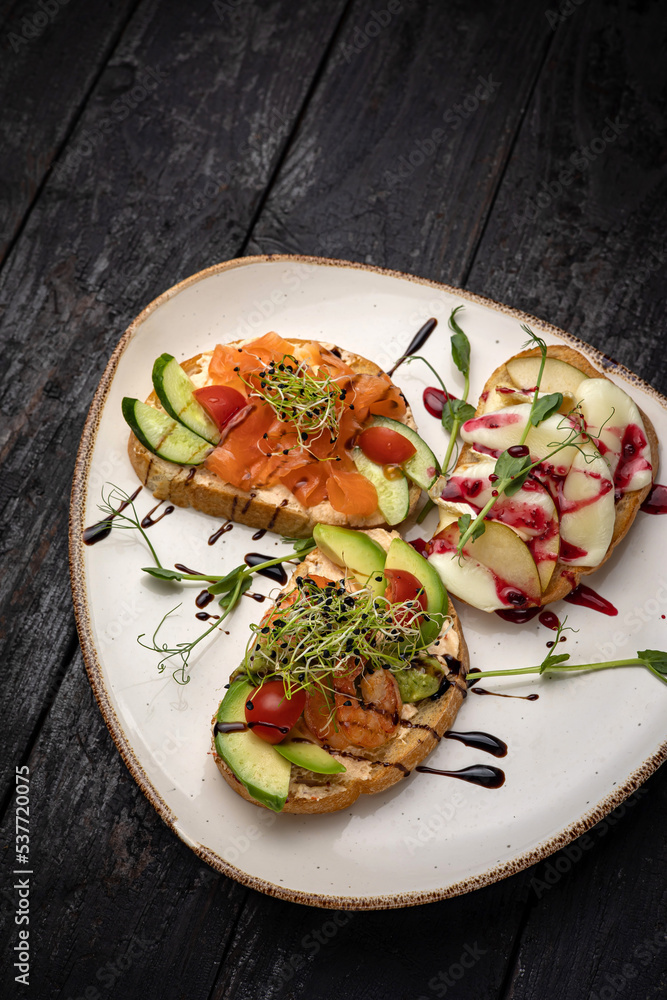 sandwich with salmon, avocado, tomato and cheese. healthy breakfast. sandwich with salmon, avocado, tomato and cheese. healthy breakfast.