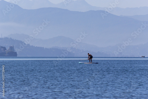 Silhouette of a man on stand up paddle board. SUP