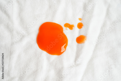 Dirty spicy sauce stain on cloth to wash with washing powder, cleaning housework concept.
