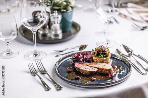 Creatively duck breast served on a ceremonially prepared table in the hotel restaurant