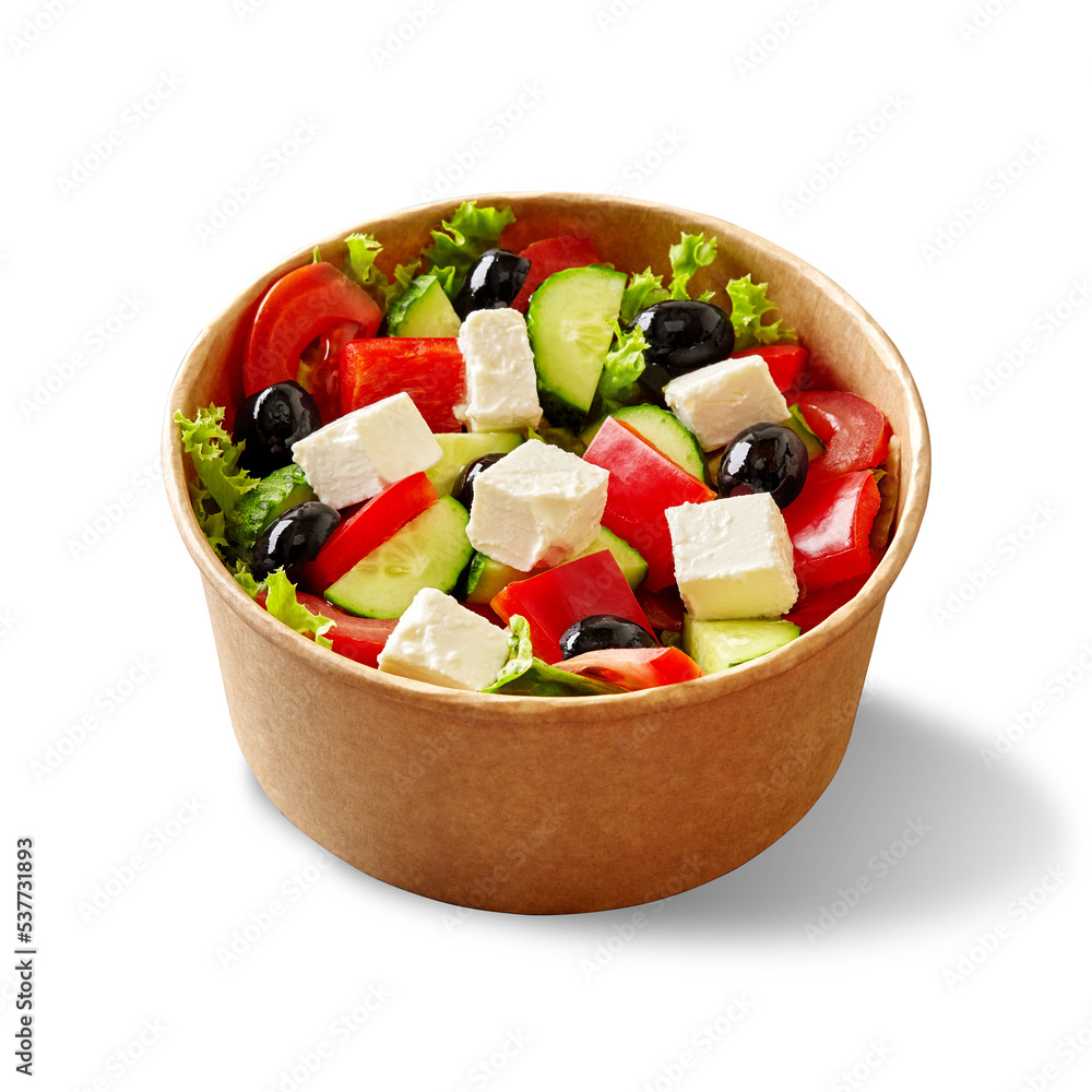 Paper bowl of greek salad with fresh vegetables, feta cheese and black olives isolated on white