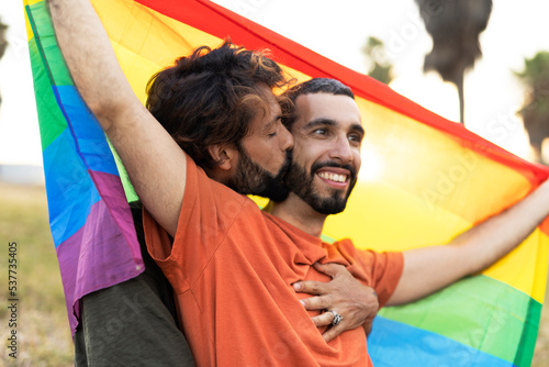 Happy couple with a pride flag. LGBT community