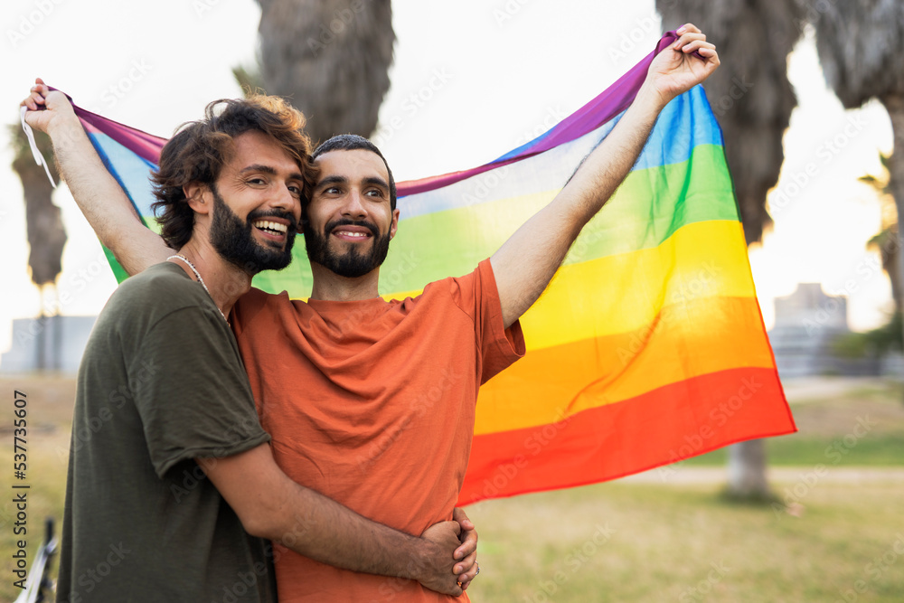 Happy couple with a pride flag. LGBT community Happy couple with a pride flag. LGBT community