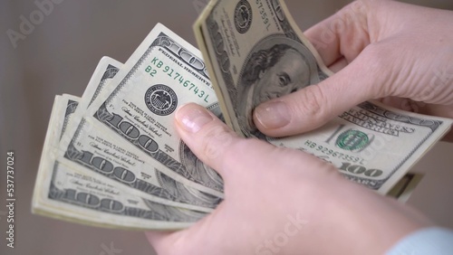 Close-up of female hands counting dollars