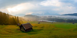 Small cabin on mountain meadow at forest edge, Geroldsee in the background Karwendel Mountains at sunrise, Kaltenbrunn, Upper Bavaria, Germany