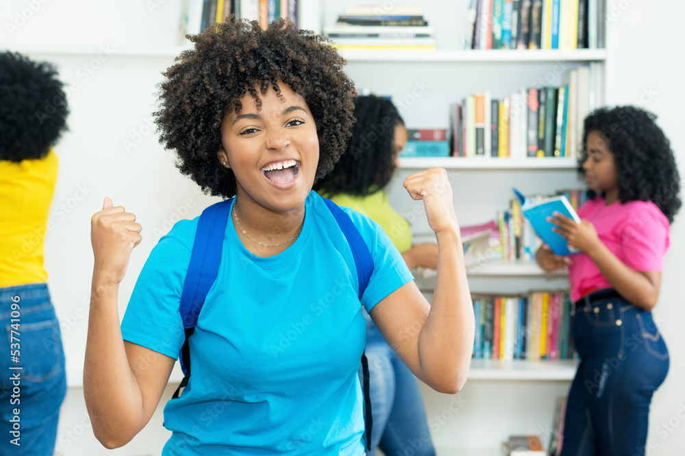 Fototapeta premium Cheering black female student with group of african american college students