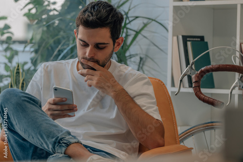 young man at home with mobile phone