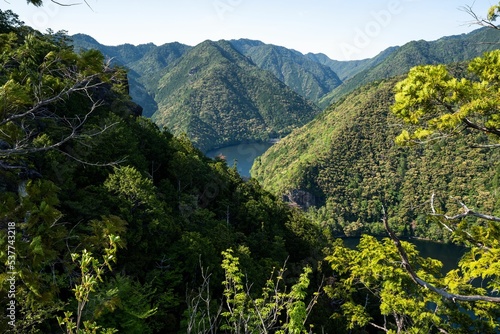 Aerial view of lakes between mountains covered with Shinshiro forest in Japan photo